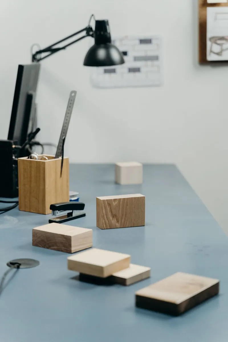 Échantillons de bois et de pierre disposés sur la table de travail de l'atelier.